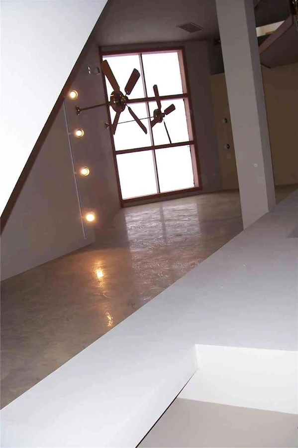 Loft conversion with freshly plastered walls and vaulted ceiling