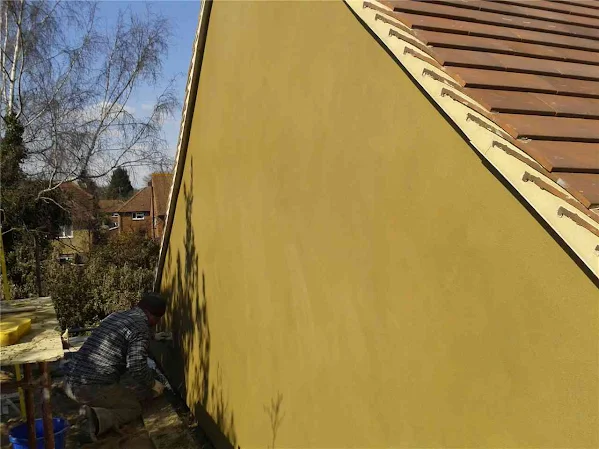 Yellow gable render finish on detached property