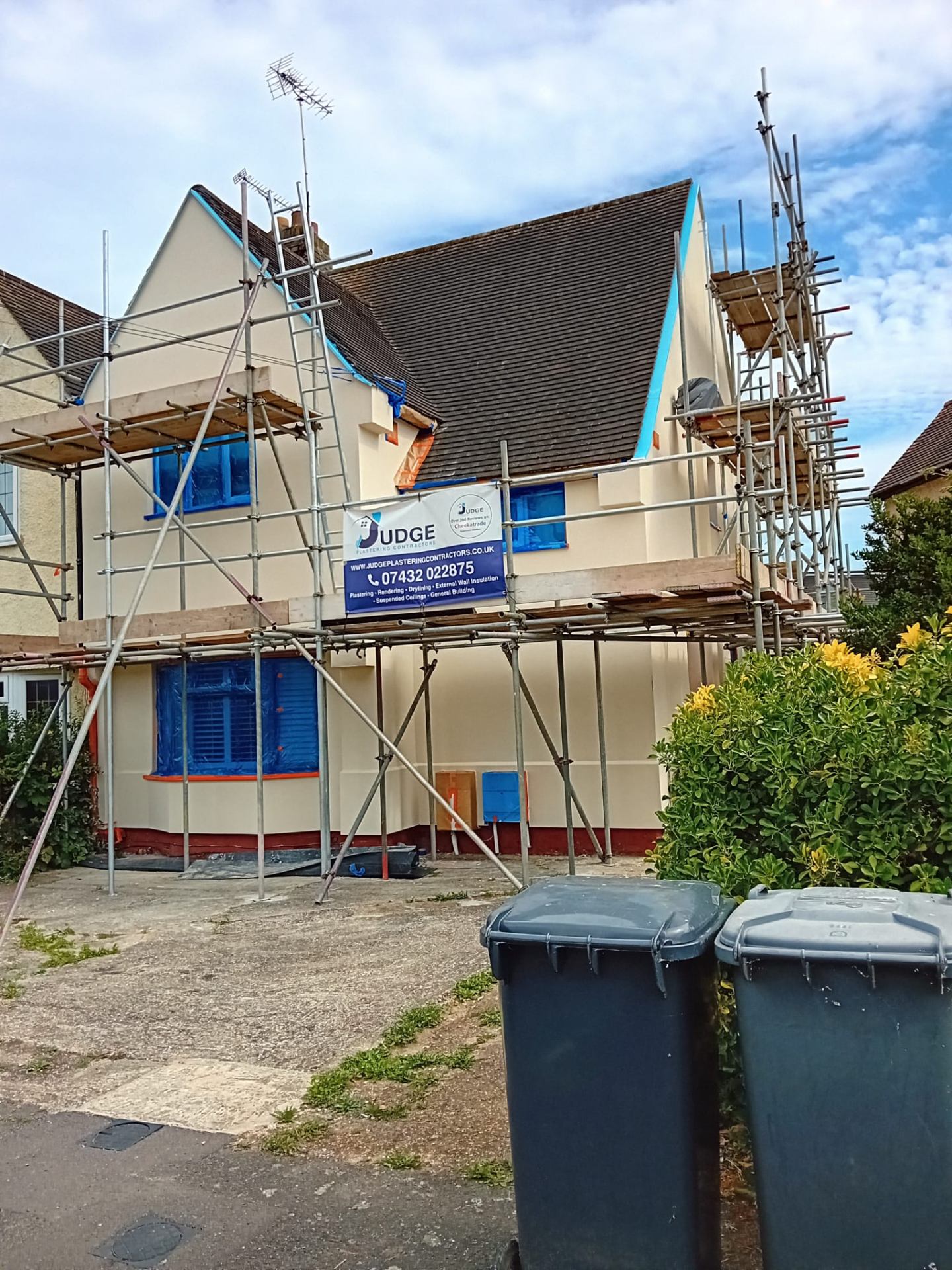 Professional plastering contractors at work on a residential project