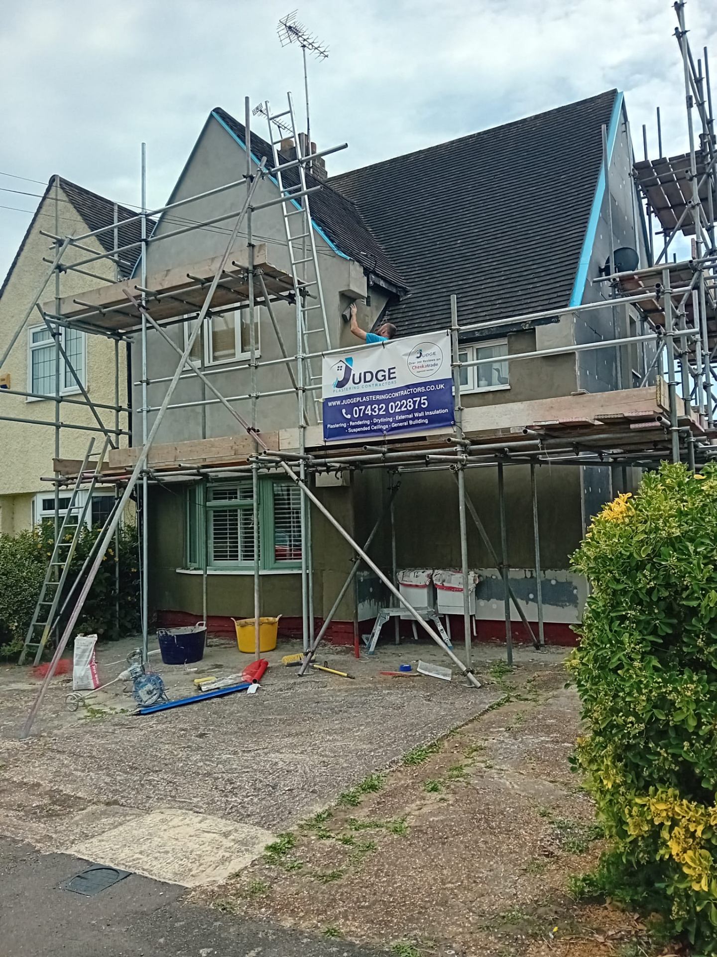 External rendering project in progress with company scaffold banner